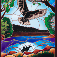 Stained Glass style, design a stained glass window arched at the top of a river scene with Bunjil the wedge tail eagle gliding above a river lined with trees and grasses. there is an aboriginal campfire by the water